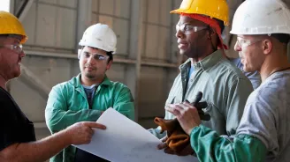 Workers discussing plans