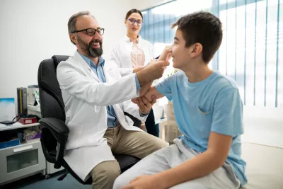 Two Physicians Before a Sports Physical on a Teenage Boy