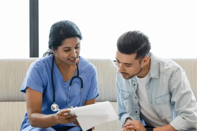 A Doctor Goes Over a Chart with her Patient