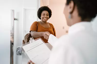 Woman shaking her doctor's hand.