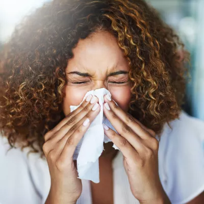 A Woman Blows Her Nose