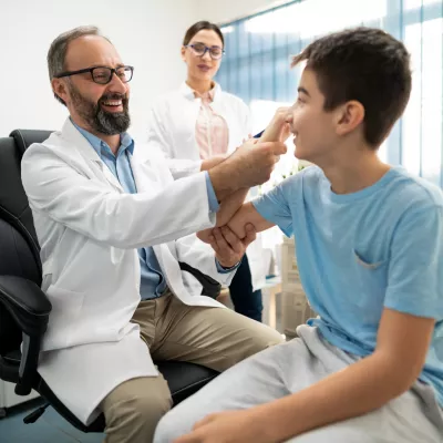Two Physicians Before a Sports Physical on a Teenage Boy