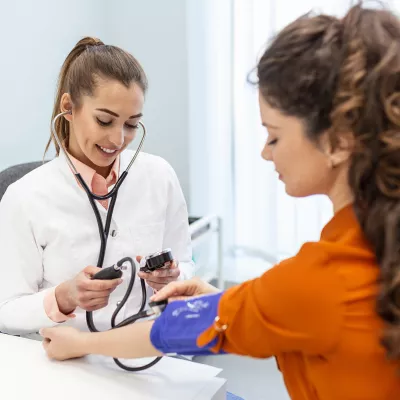 A Provider Takes Her Patient's Blood Pressure