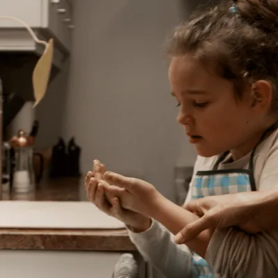 Child examining a burn in the bathroom with parent