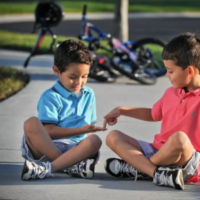 Kids Playing on Sidewalk with Bikes