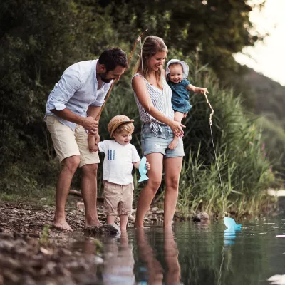 A family standing by the water.