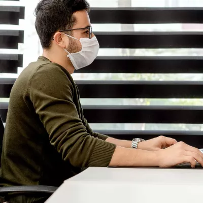 A man at work wearing a face mask.