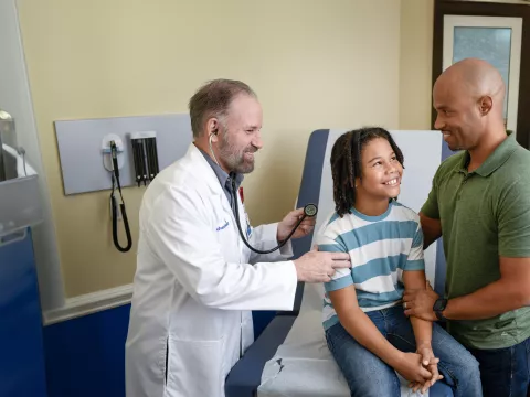 Centra Care Provider Check's a Child Patient's Breathing