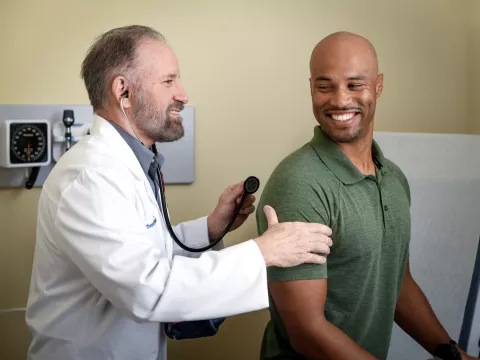 A Physician Examines a Patient in an Exam Room