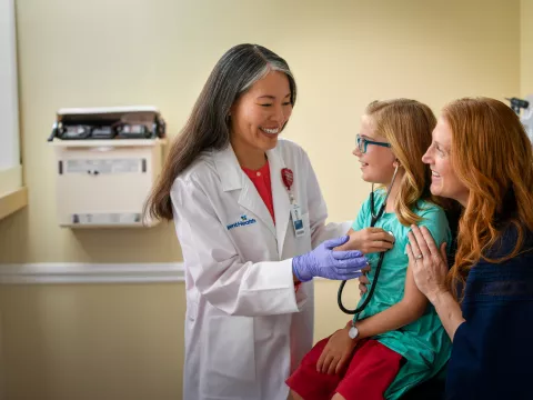 Centra Care Provider Shows a Young Patient How to Listen to Her Heart Beat