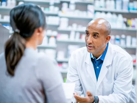 A Pharmacist Speaks to a Patient About Medication