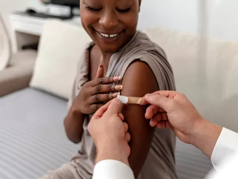 A Woman Smiles After Receiving Her Flu Shot