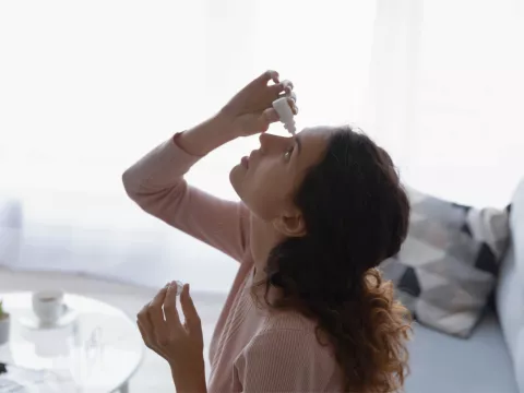 A Woman Gives Herself Eye Drops