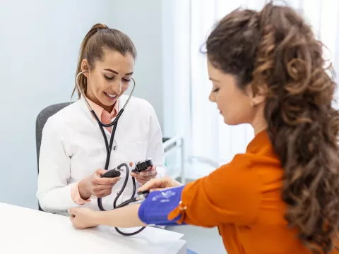 A Provider Takes Her Patient's Blood Pressure