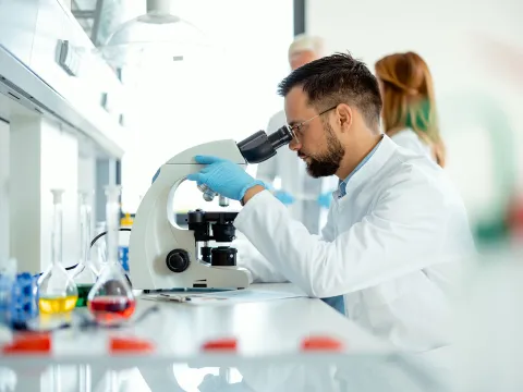 Scientist looking in microscope