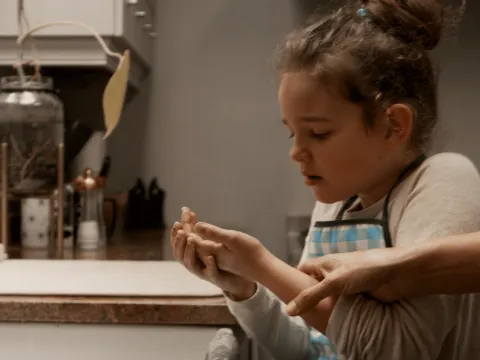 Child examining a burn in the bathroom with parent