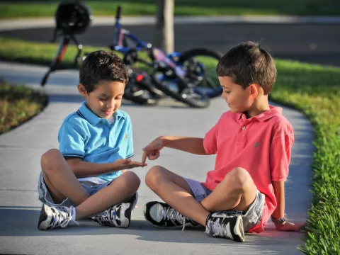 Kids Playing on Sidewalk with Bikes