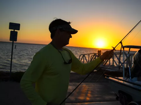 Man fishing during sunset,