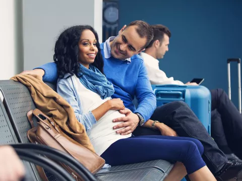 Pregnant woman with husband in airport
