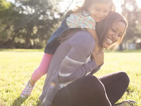Daughter climbing on her Mother