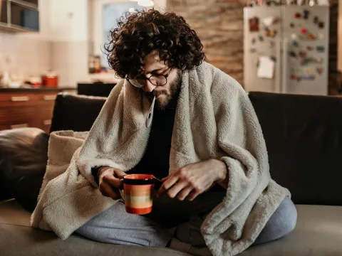 A young man sick at home