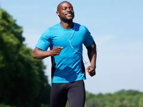 A man running outside while listening to music.