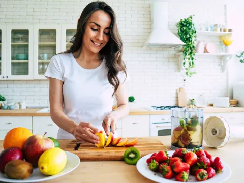 A young woman prepping food at home.