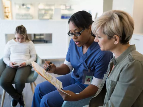 A woman reviews her test results with her doctor.