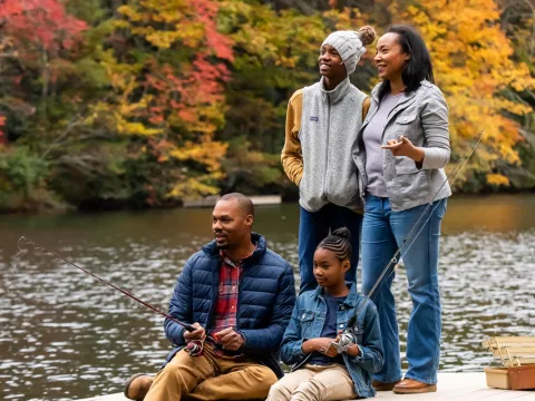 Family fishing by the lake in the Fall.