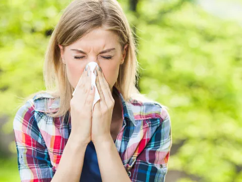 Woman Sneezing Outdoors