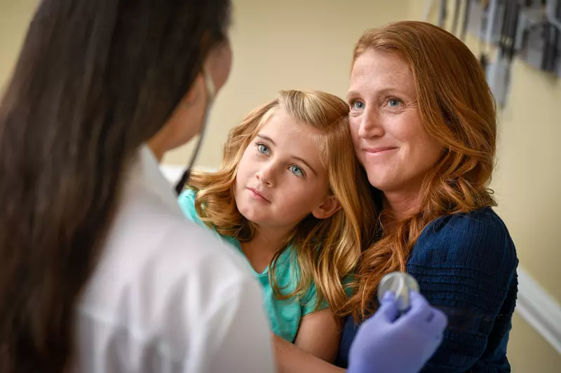 A Little Girl and Her Mother Speak to a Physician. 