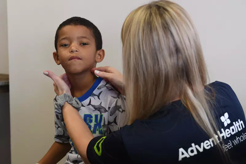 AdventHealth doctor conducts school entry physical on child 