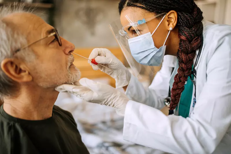 A Provider Swabs a Man's Nose for Testing Purposes