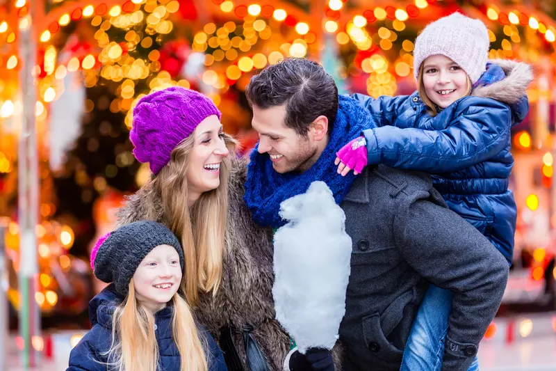 A family at a Christmas festival.