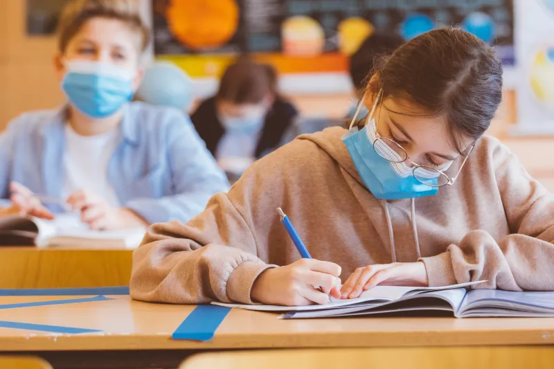 Children wearing masks in the classroom.