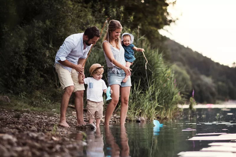 A family standing by the water.