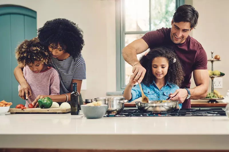 A family cooking a healthy meal together.