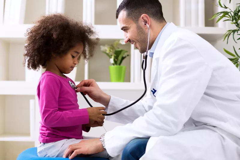 A little girl gets a check up at her doctor's office.