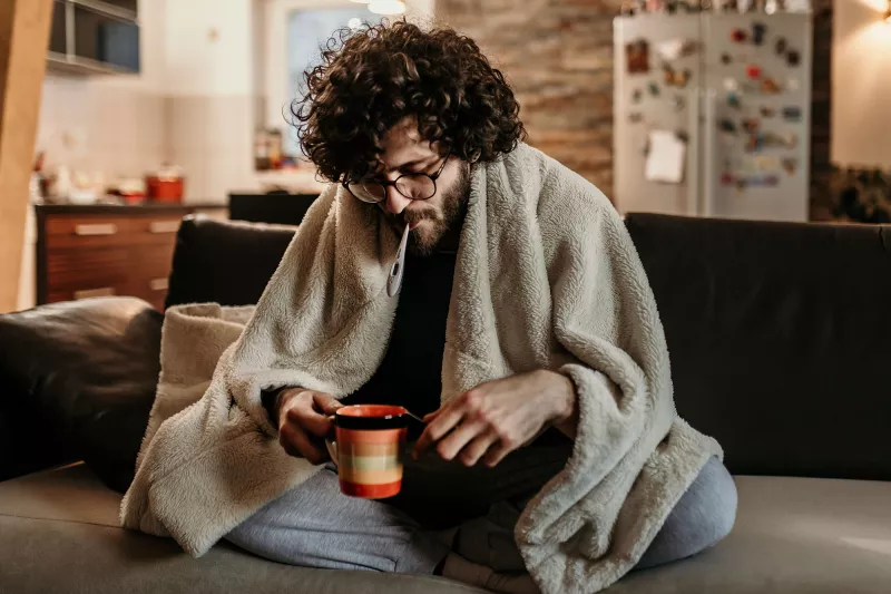 A young man sick at home