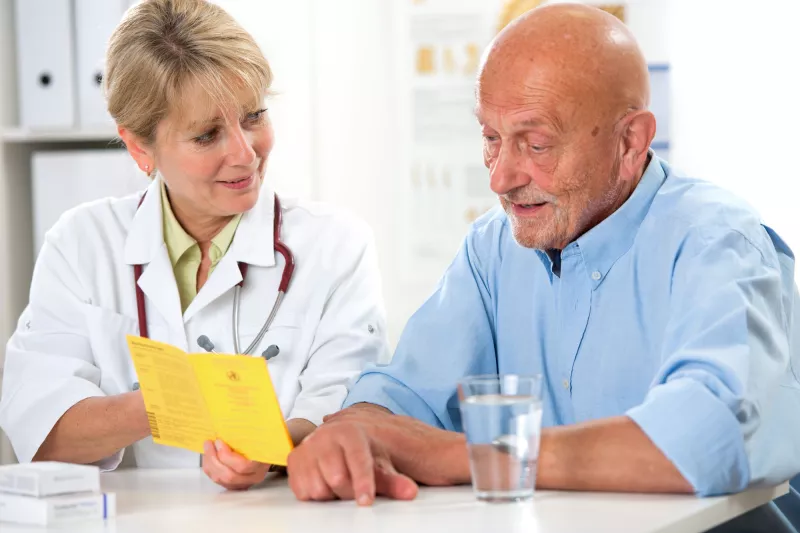 A man discusses his condition with his doctor.