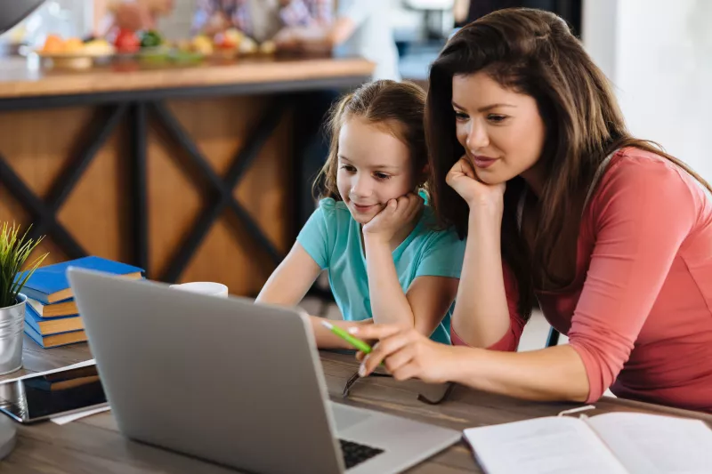 Mother and daughter at computer.