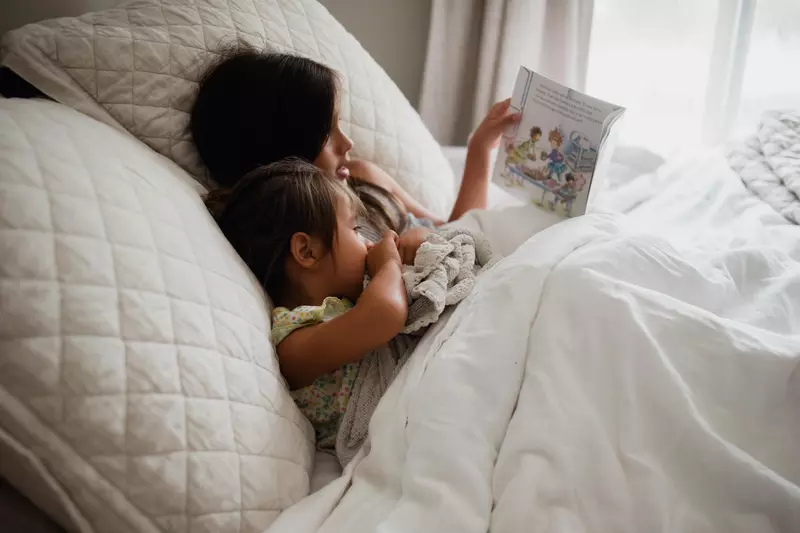 Older child reading to younger child