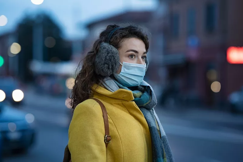 A young woman with winter gear while in her local city.