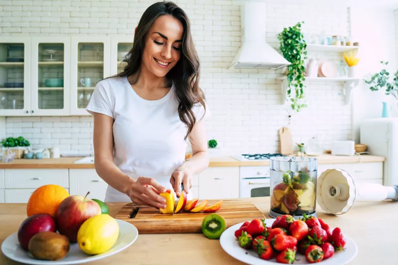 A young woman prepping food at home.