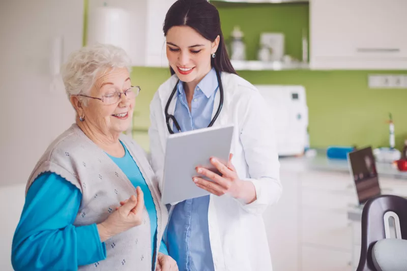 A woman reviews her test results with her doctor.