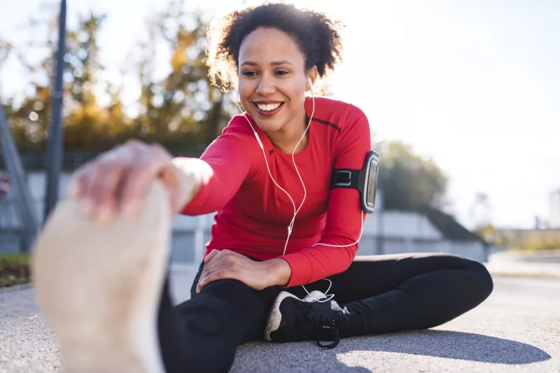 A woman stretching after a run.