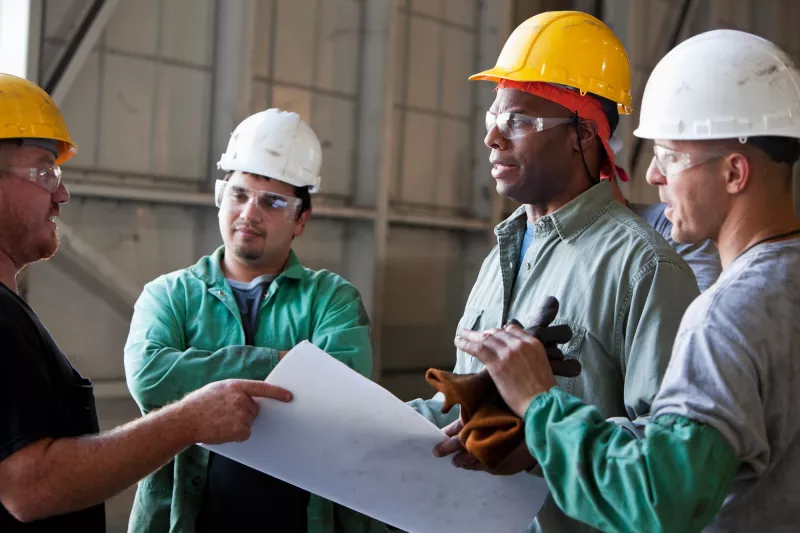 Workers discussing plans