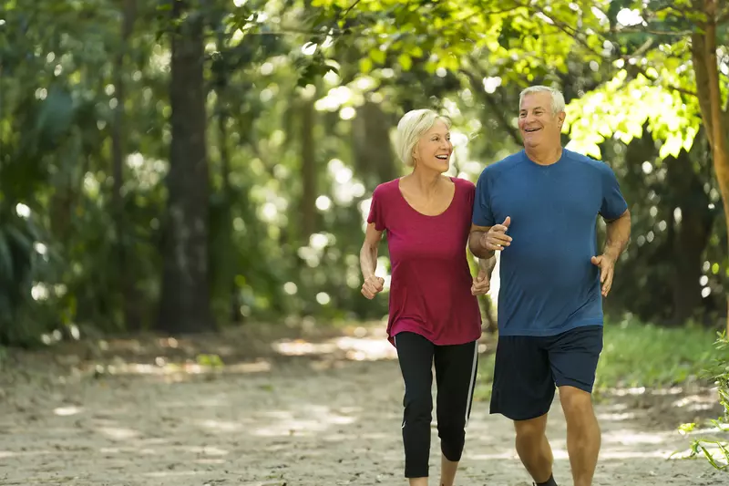 Older couple Jogging through the woods