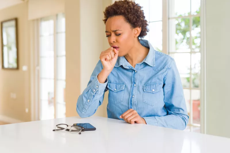 A woman coughing.