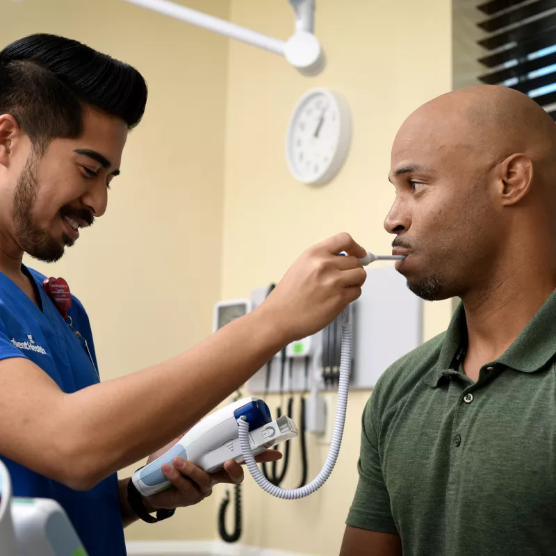 A Nurse Takes a Patient's Temperature 